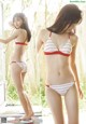 A woman in a red and white striped bikini posing for a picture.