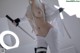 A woman in a white outfit holding a sword.